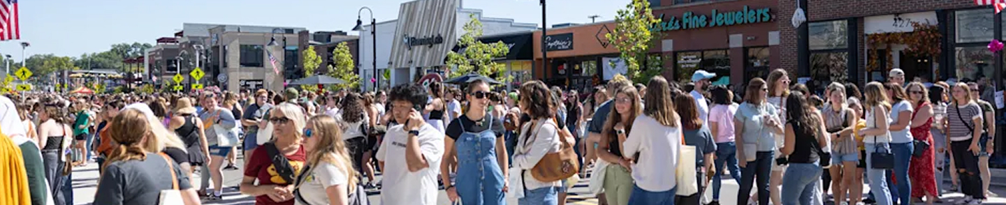 Large gathering of people in a small downtown area