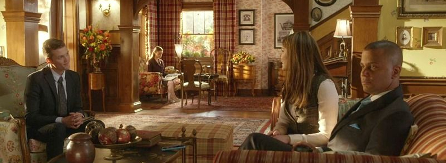 three people sitting on couches in a lobby of an Inn